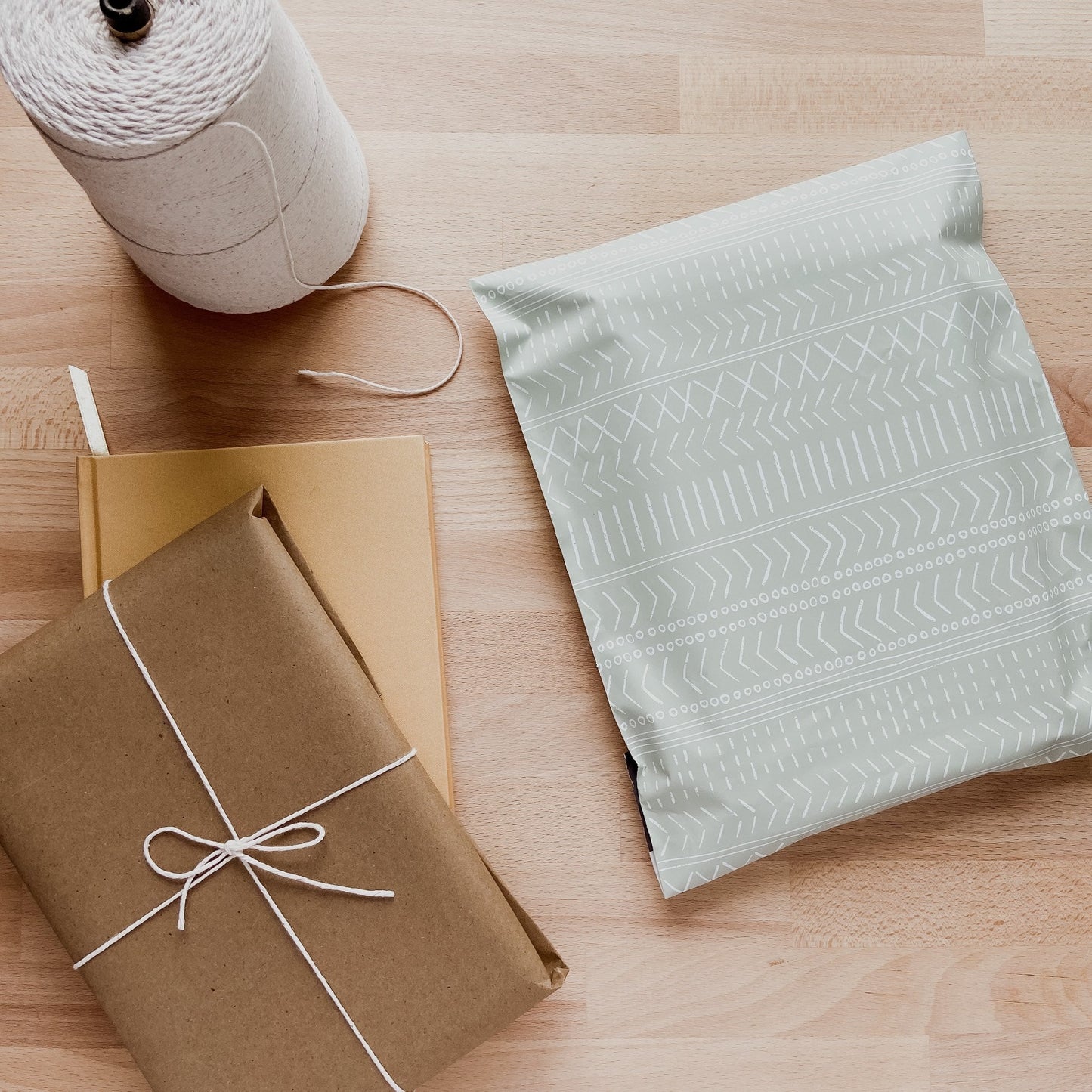 a small business view of packed orders in a sage green polymailer with a minimalist print